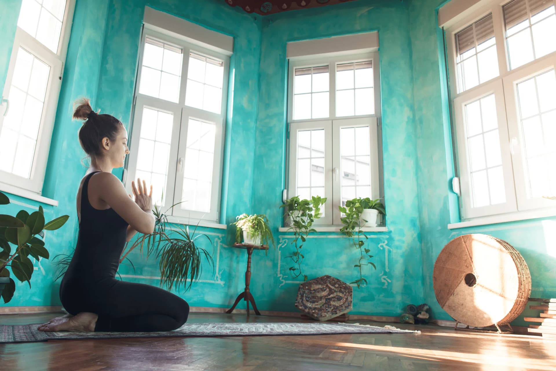 Person practicing morning routine with meditation and exercise for productivity