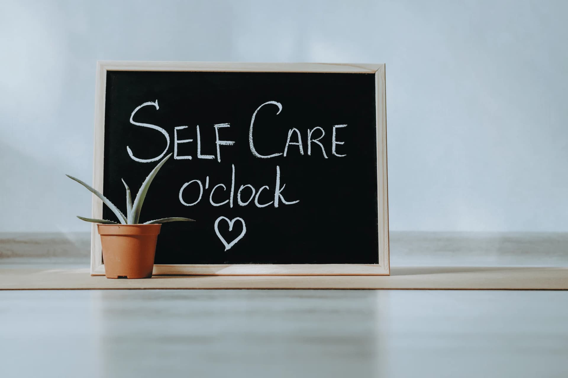 Person practicing mindful self-care and delegating tasks for better work-life balance in 2025