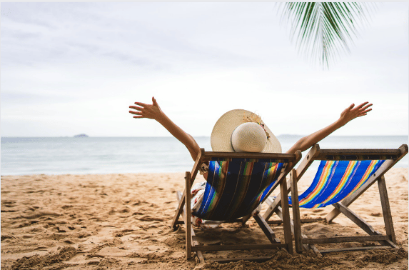 Entrepreneur relaxing on vacation while their virtual assistant handles business operations
