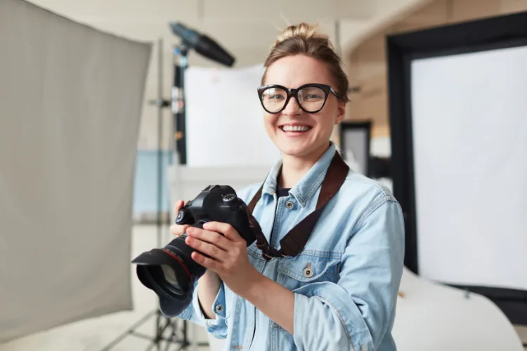Photographer reviewing images while Virtual Assistant handles scheduling and client communication