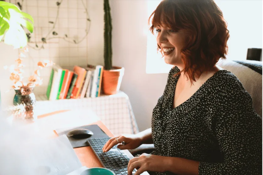 Virtual Assistant working at computer developing a monthly marketing plan for clients