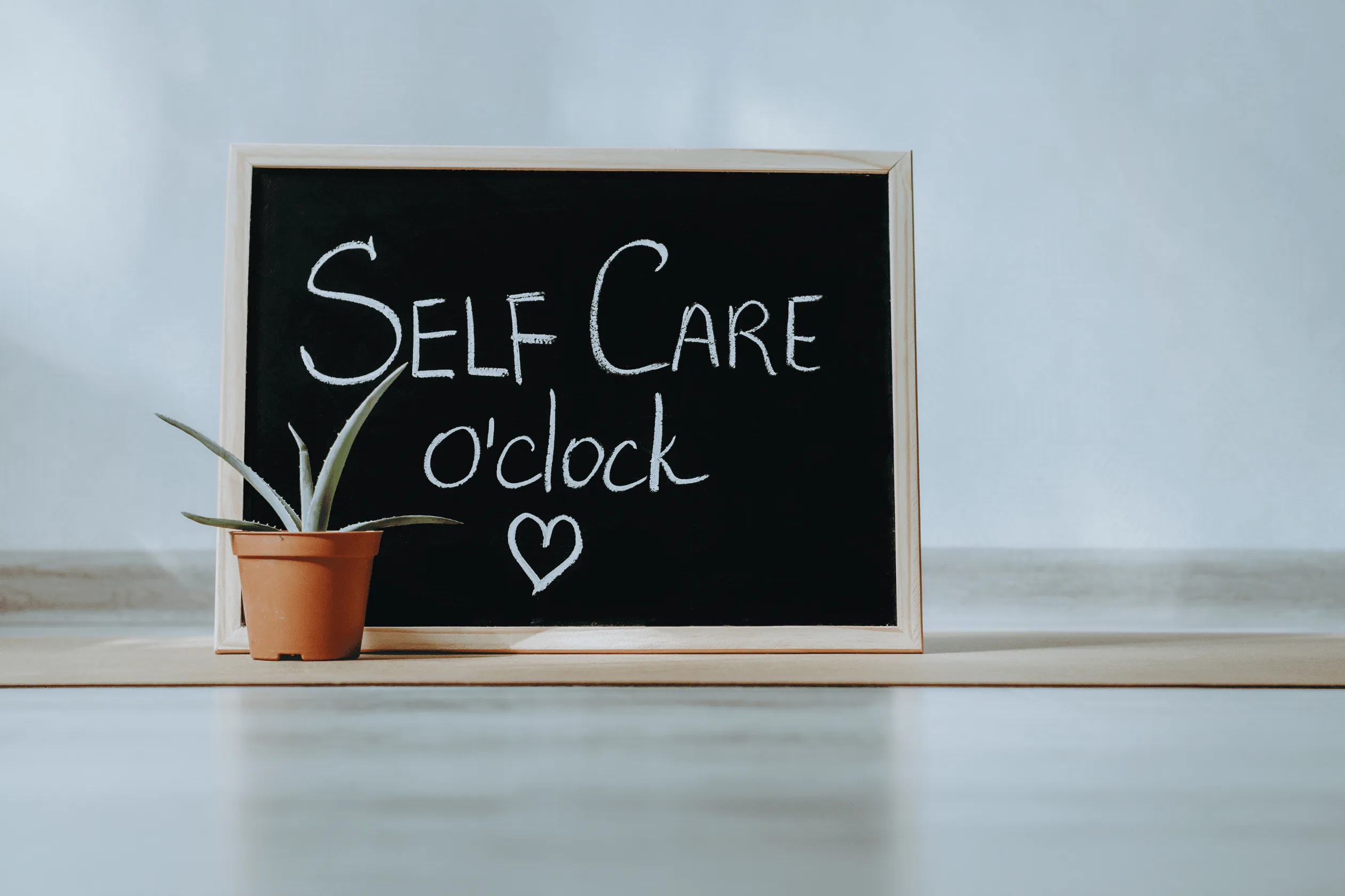 Person practicing mindful self-care and delegating tasks for better work-life balance in 2025