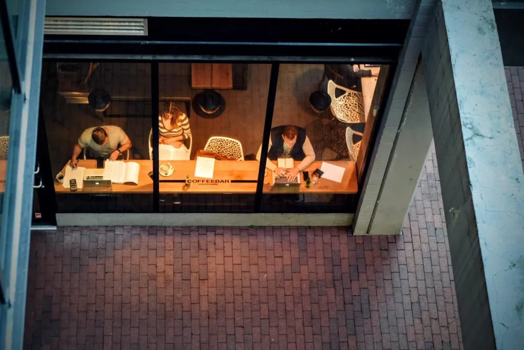 Professional working at desk with laptop comparing staffing costs and business expenses