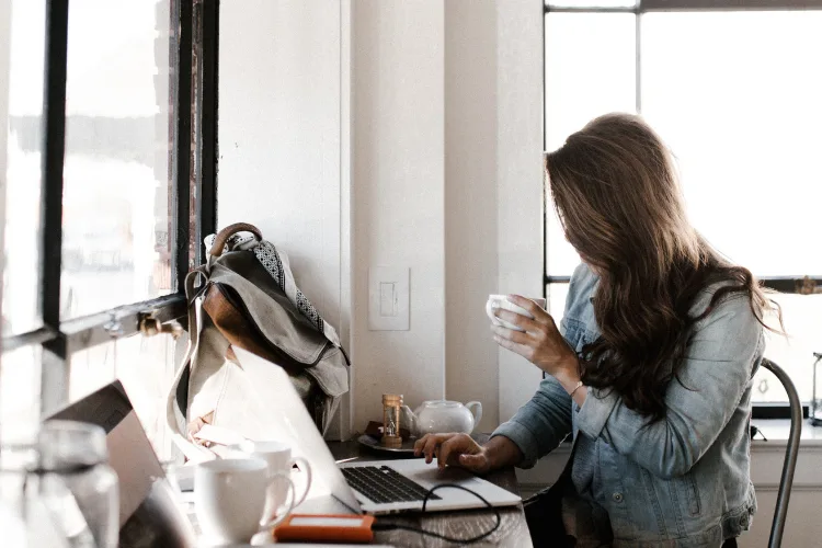 Woman working remotely from home as a virtual assistant with laptop and flexible schedule